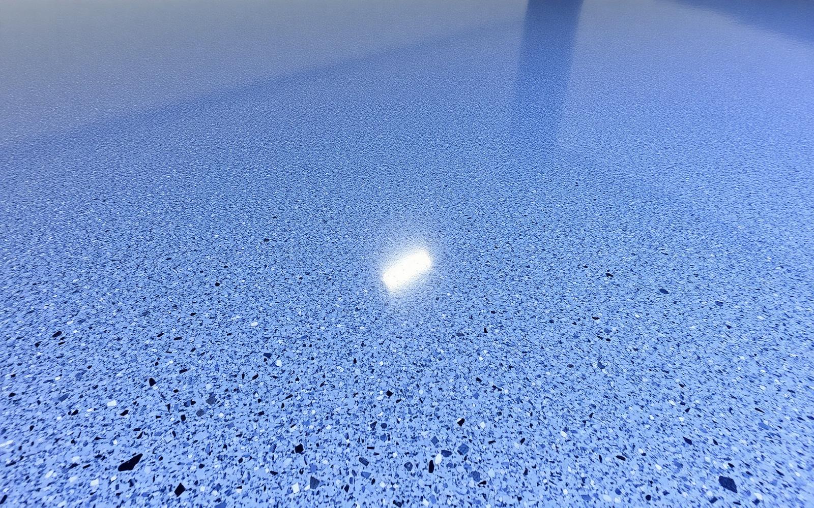 Close-up of a finished blue-gray flake epoxy garage floor surface under a clear topcoat